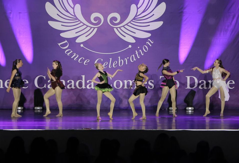 Group of 6 young dancers on scene in a dance event
